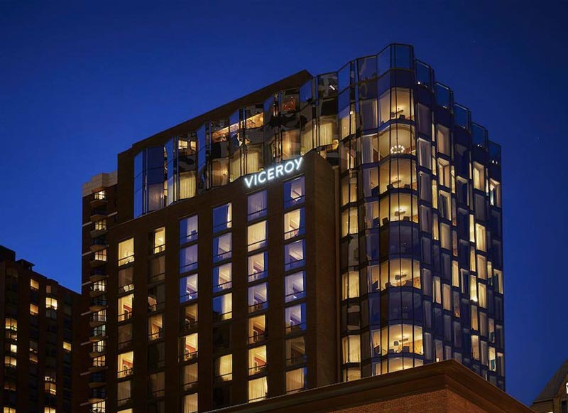 Exterior photo of the Viceroy Chicago, lit up at night.